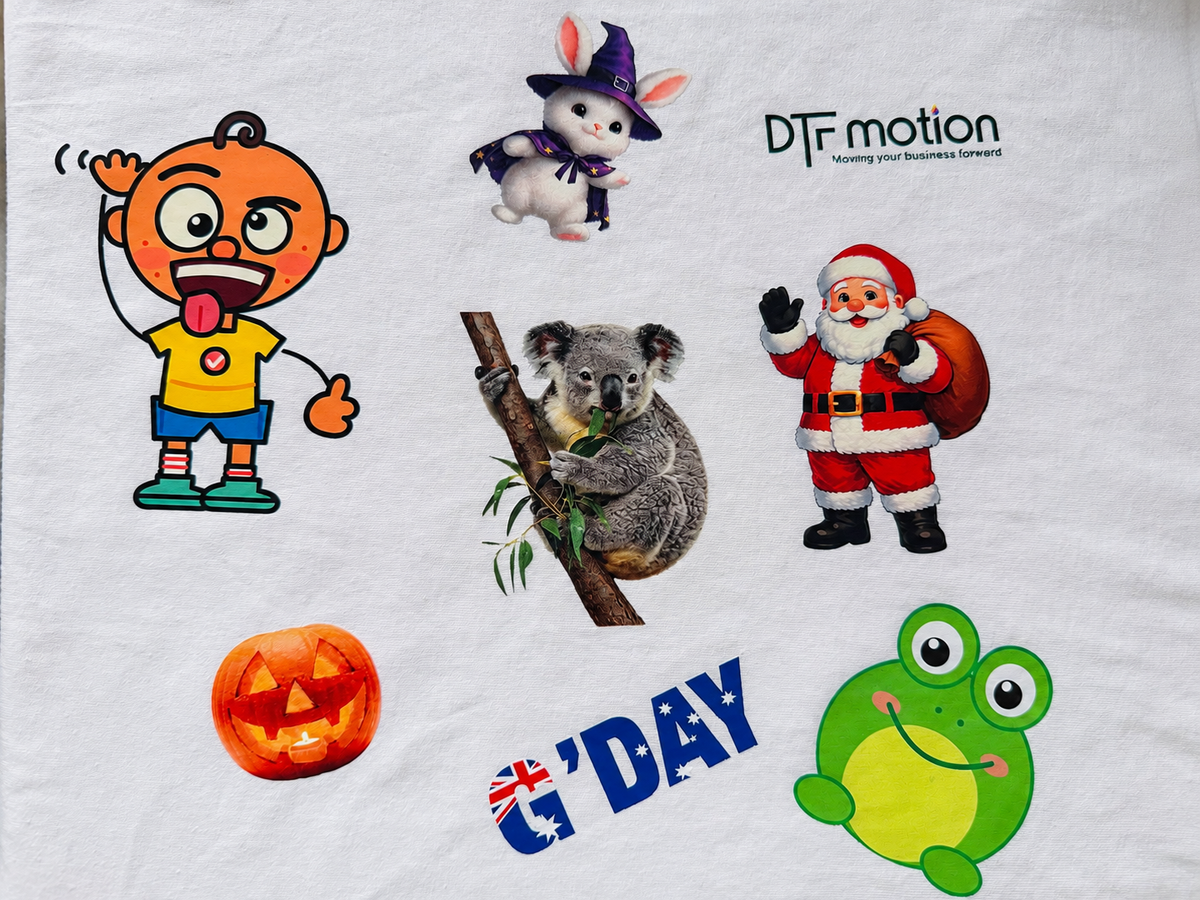 DTF transfers pressed onto a white cotton garment - koala, Santa, frog and G'Day designs